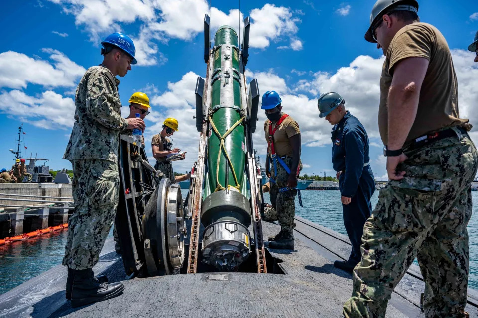 Sailors assigned to the Los Angeles-class fast-attack submarine USS Columbia (SSN 771) load a Mark 48 advanced capability torpedo for Exercise Agile Dagger 2021 (AD21).