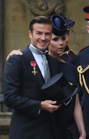 <p> JASPER JUINEN/AFP via Getty</p> David and Victoria Beckham make their way into Westminster Abbey for Kate Middleton and Prince William's wedding in April 2011.