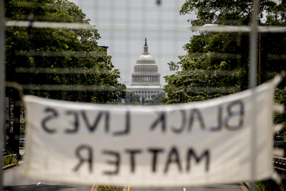 The dome of the U.S. Capitol is visible as a sign that reads "Black Lives Matter" hangs on an overpass on North Capitol Street in Washington, Tuesday, June 2, 2020, following days of continuing protests over the death of George Floyd. Floyd died after being restrained by Minneapolis police officers. (AP Photo/Andrew Harnik)