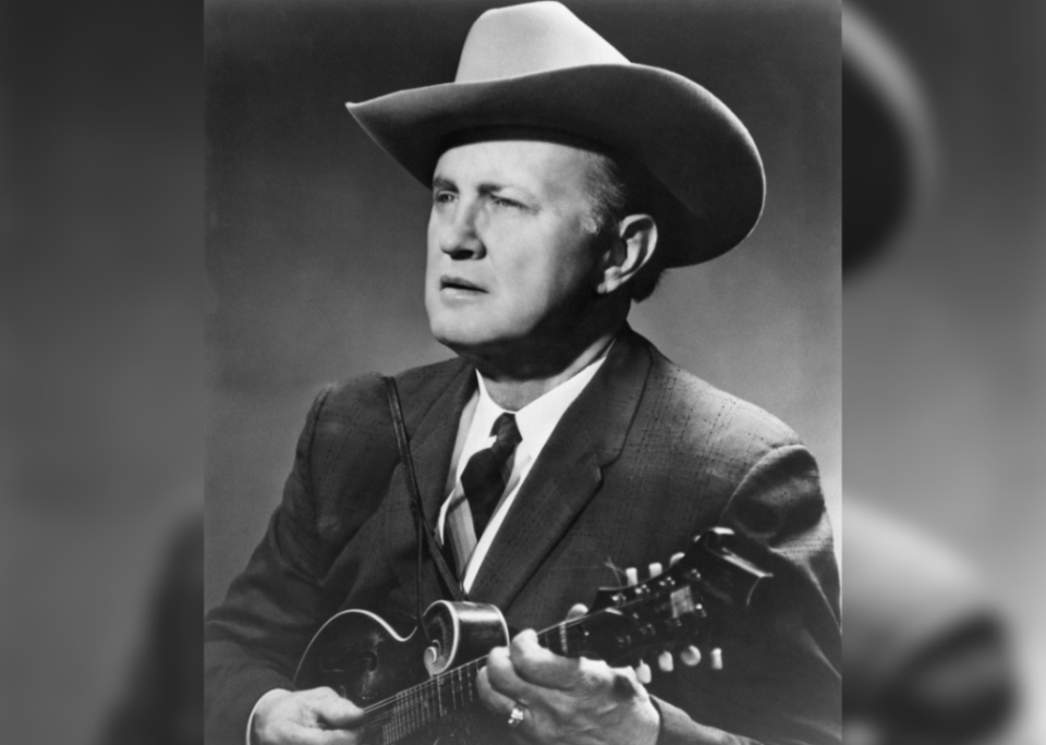 Bill Monroe poses with a mandolin.