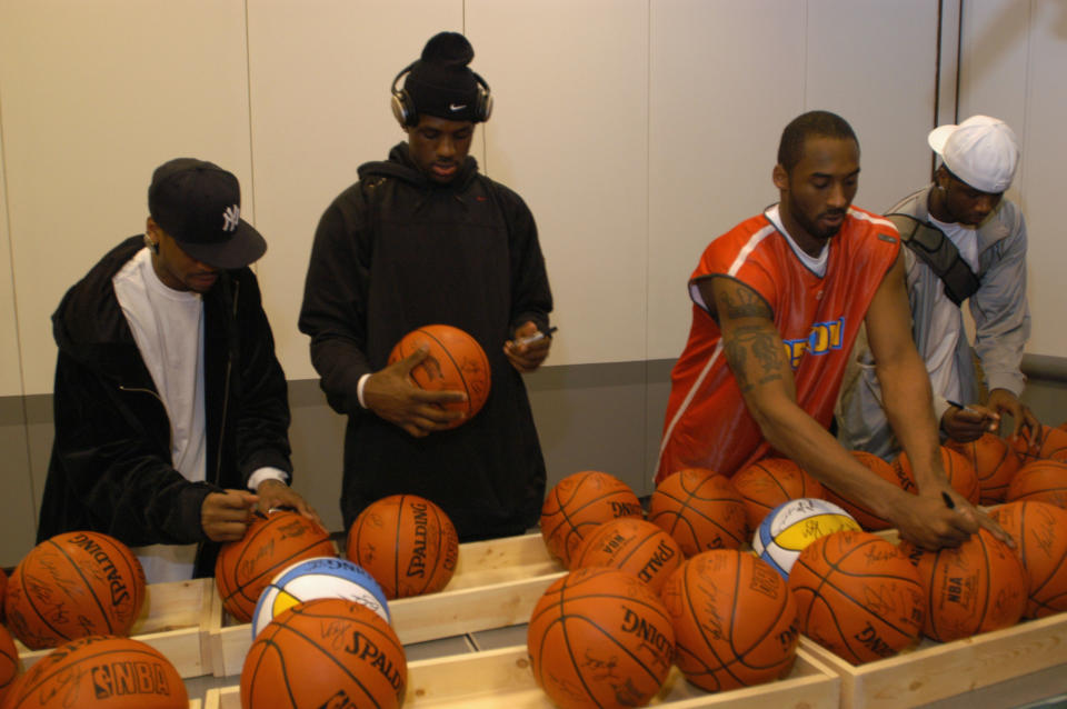 Allen Iverson, LeBron James and Kobe Bryant sign autographs at the 2005 NBA All-Star Game. (Getty Images)