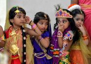 <p>Indian children dressed as the Hindu deity Krishna and his cosort Radha wait in line to participate in a fancy dress competition held as part of Krishna Janmashtami celebrations at a kindergarten in Bangalore on September 1, 2018. – Krishna Janmashtami is an annual Hindu festival that celebrates the birth of the Hindu deity Krishna, the eighth avatar of Vishnu. (Photo by MANJUNATH KIRAN/AFP/Getty Images) </p>