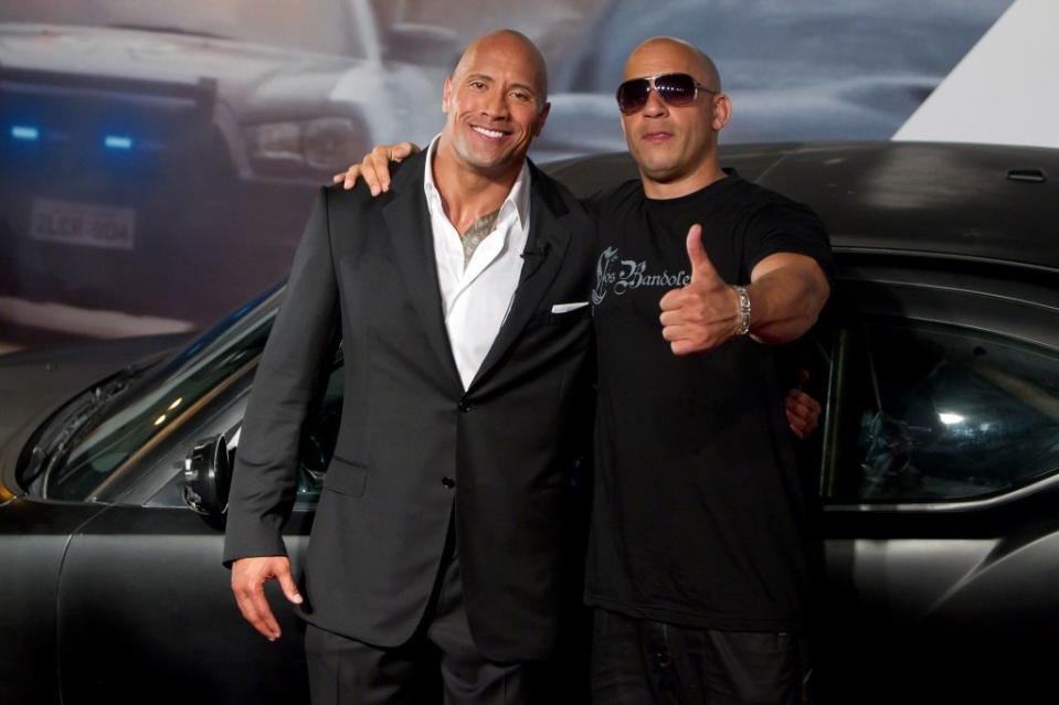 Johnson and Diesel pose for photographers during the premiere of the movie “Fast and Furious 5” at Cinepolis Lagoon on April 15, 2011, in Rio de Janeiro, Brazil. LatinContent via Getty Images