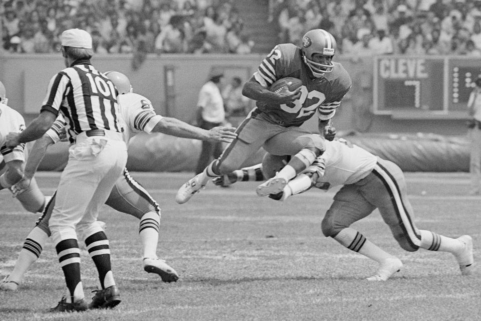 San Francisco 49er O.J. Simpson takes to the air as Cleveland Brown's Thom Darden makes the tackle during the second quarter of an NFL football game, Sept. 3, 1978, in Cleveland, Ohio. Simpson, the decorated football superstar and Hollywood actor who was acquitted of charges he killed his former wife and her friend but later found liable in a separate civil trial, died Wednesday, April 11, 2024, of prostate cancer. He was 76. (AP Photo/File)