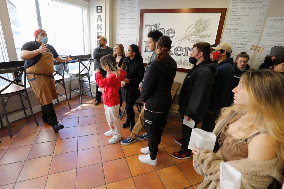 Brandon Roderick, owner of The Baker in downtown New Bedford, speaks with Greater New Bedford Regional Vocational Technical High School sophomore culinary arts students during their "tiny kitchen tour."