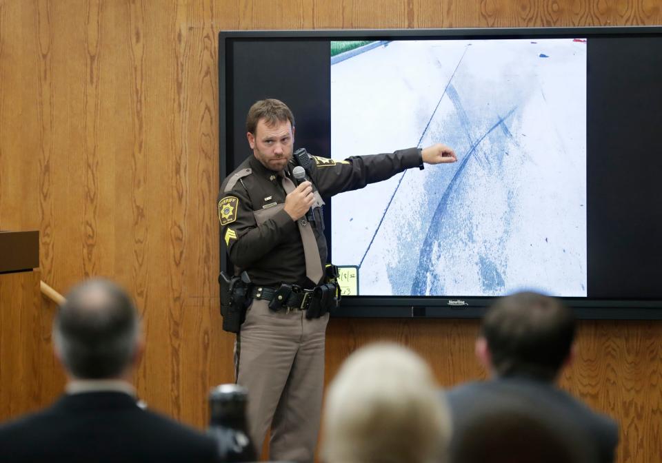 Sgt. Ryan Zitlow of the Fond du Lac County Sheriff's Department points to a photo of motorcycle tracks while answering questions from District Attorney Eric Toney on Tuesday in Fond du Lac.