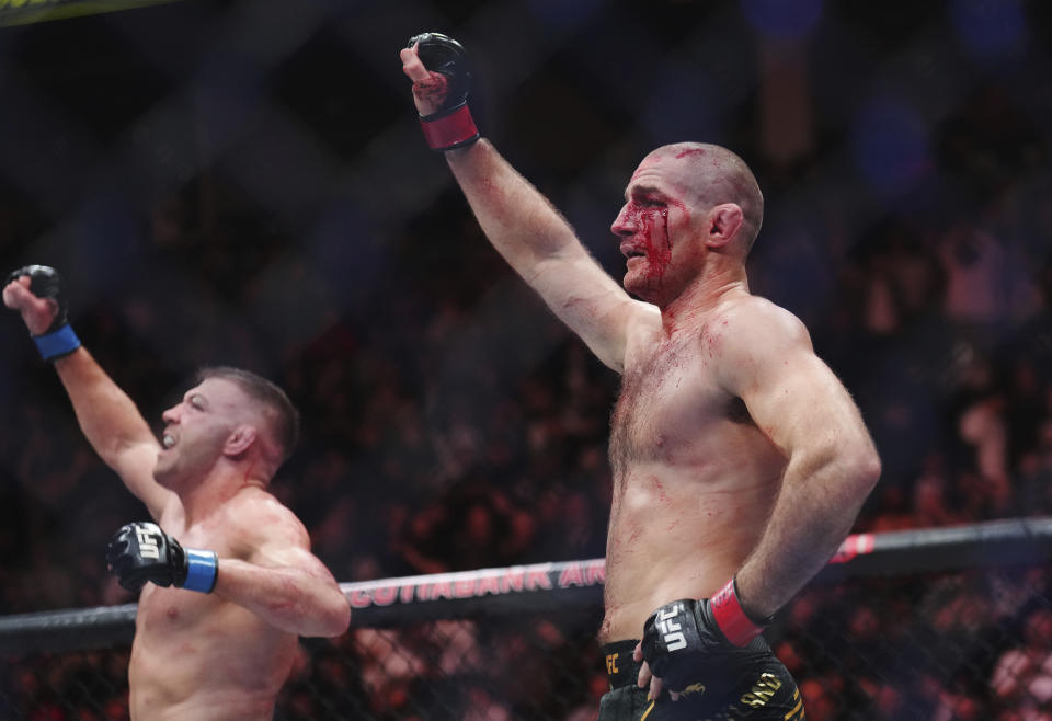 Sean Strickland, right, and Dricus Du Plessis acknowledge the crowd following a middleweight title bout during the UFC 297 mixed martial arts event in Toronto early Sunday, Jan. 21, 2024. (Nathan Denette/The Canadian Press via AP)