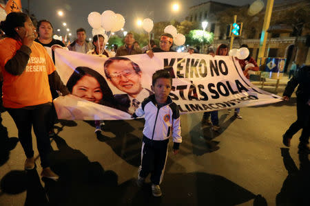 Supporters of Keiko Fujimori, daughter of former president Alberto Fujimori and leader of the opposition in Peru, protest against her detention in Lima, Peru October 15, 2018. The banner reads: "Keiko is not alone; Lima with you". REUTERS/Guadalupe Pardo