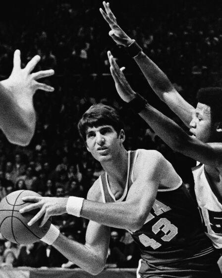 UCLA's Greg Lee looks for a teamate to pass to as Note Dame's Dwight Clay presses