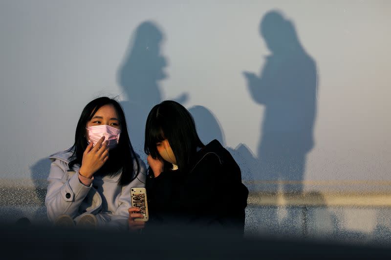 People wearing protective masks are seen at the Shibuya sky observation deck, following an outbreak of the coronavirus in Tokyo