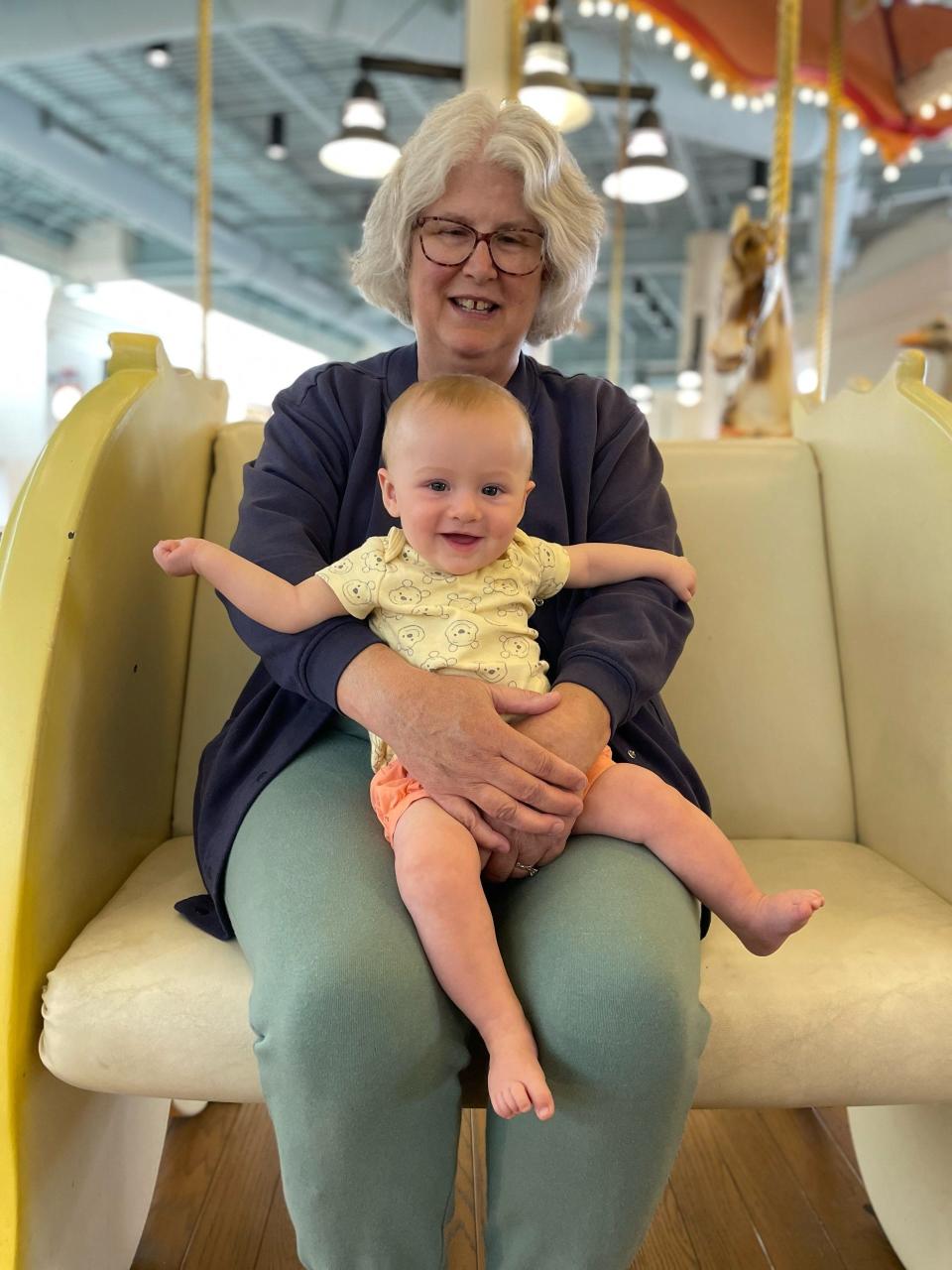 Emmy Yoder, 62, holds her granddaughter, whom she can now watch full-time thanks to the relief she received through the one-time adjustment. The now-retired teacher in Missouri was denied forgiveness despite being eligible for it through various programs. Hefty interest made it difficult to shrink the debt.