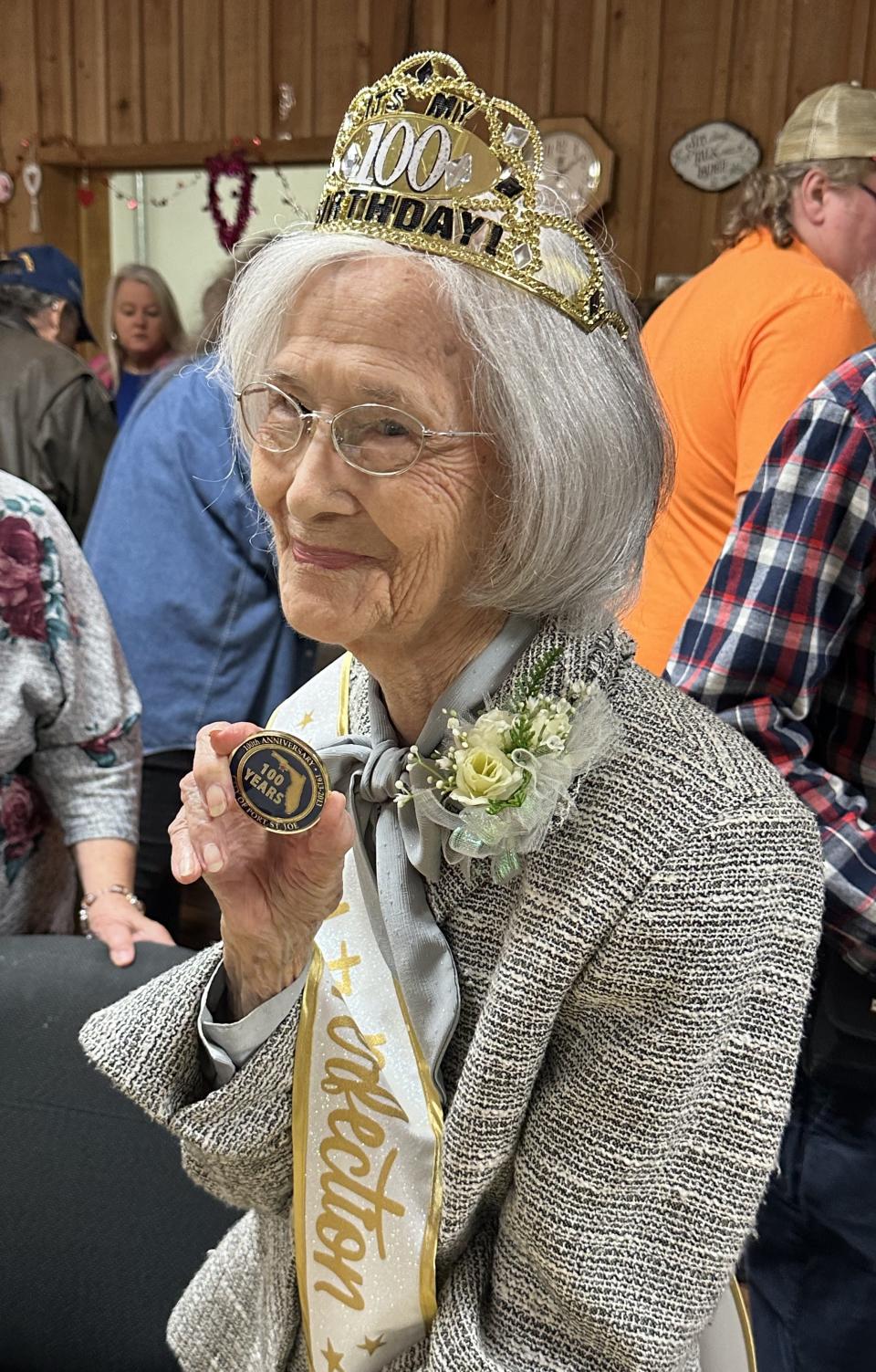 Era Herring Luckie Daniell shows off her 100 coin given to her by the mayor of Port St. Joe.