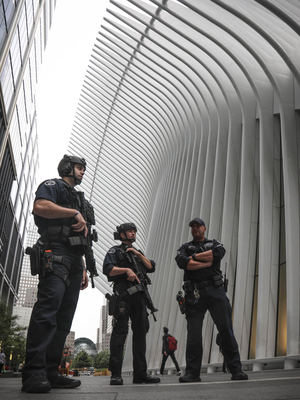 NYPD anti-terror officers show increase security in area around the Fulton Street subway hub, during investigation of a suspicious item, Friday Aug. 16, 2019, in New York. Two abandoned objects that appeared to be pressure cookers prompted an evacuation of a major lower Manhattan subway station during the morning commute Friday before police determined they were not explosives, and authorities were investigating whether they were deliberately positioned to spark fear. (AP Photo/Bebeto Matthews)