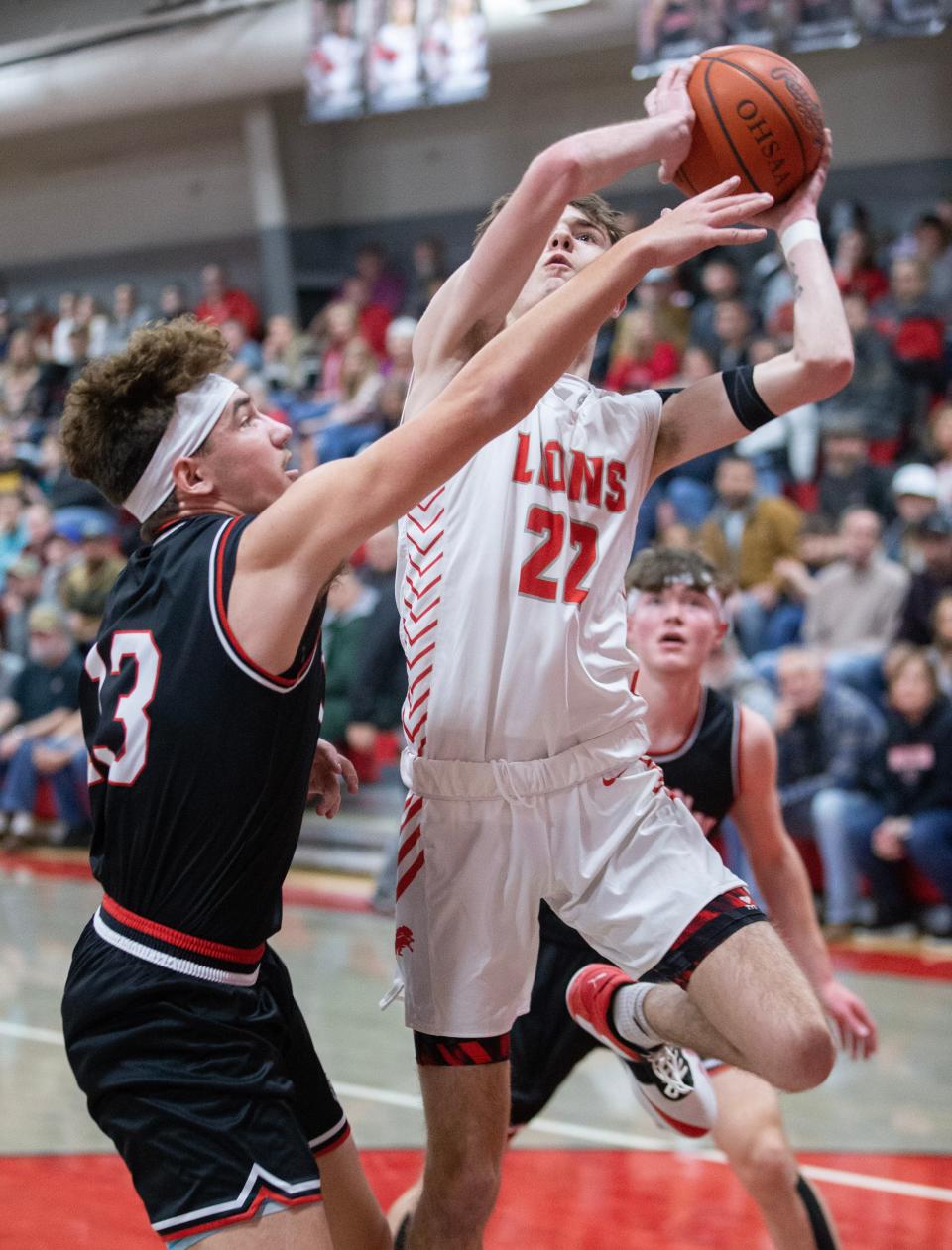 Minerva's Garrett Gonzalez shoots with defense from Carrollton's Cadyn Smith in the first half at Minerva, Friday, Feb. 3, 2023.