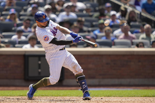 New York Mets' Gary Sanchez hits an RBI sacrifice fly off Cleveland Guardians starting pitcher Tanner Bibee (61) in the sixth inning of the opener of a split doubleheader baseball game, Sunday, May 21, 2023, in New York. (AP Photo/John Minchillo)