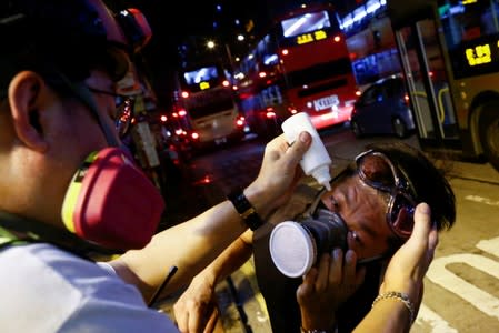 FILE PHOTO: A medic treats an anti-extradition bill protester after tear gas was fired during clashes in Sham Shui Po in Hong Kong