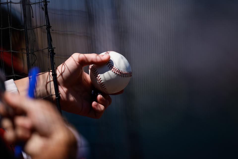 Sep 11, 2022; Denver, Colorado, USA; A fan holds a baseball through the netting looking for an autograph before the game between the Colorado Rockies and the Arizona Diamondbacks at Coors Field. Mandatory Credit: Isaiah J. Downing-USA TODAY Sports