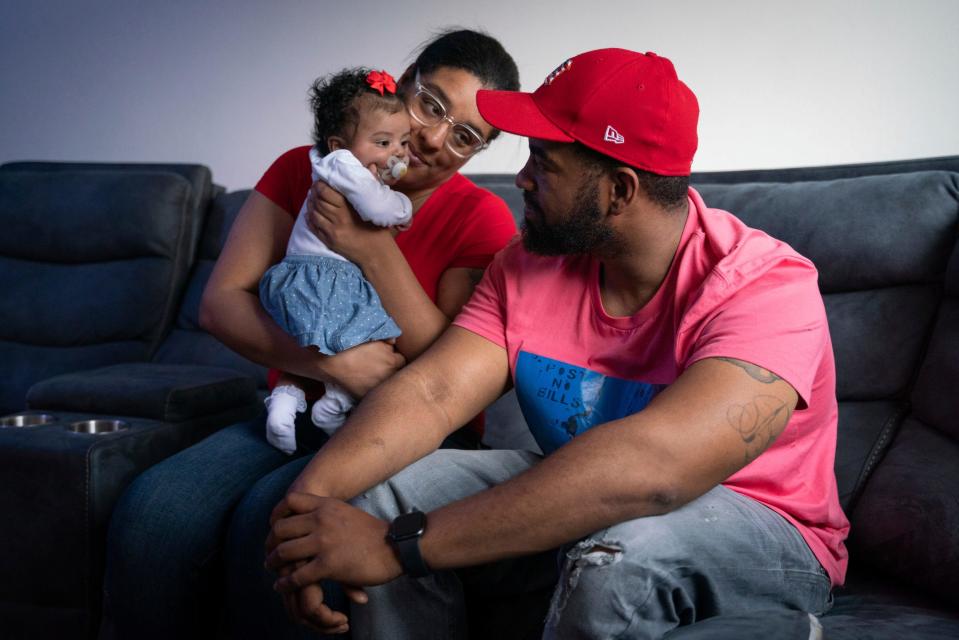 Helen, 30, left, and Brandon Woodruff, 32, look toward their 2-month-old daughter named Hailey at their home in Oak Park on Friday, May 12, 2023. "I was just thinking someone made a mistake. I was just hoping, 'I hope he doesn't get shot,'" said Woodruff, who sat in fear and confusion while learning her husband was asked to play the role of an active shooter during an unannounced drill at his job. "I thought I was going to lose my husband. I don't even know how I handle it – I don't know."