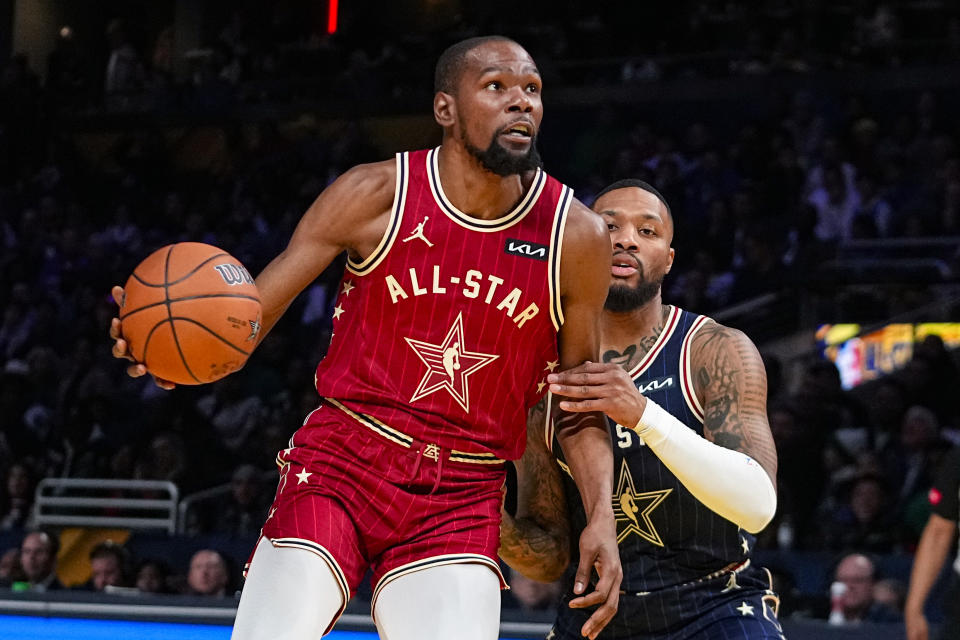 Los Angeles Clippers forward Kawhi Leonard (2) drives on Milwaukee Bucks guard Damian Lillard (0) during the first half of an NBA All-Star basketball game in Indianapolis, Sunday, Feb. 18, 2024. (AP Photo/Darron Cummings)