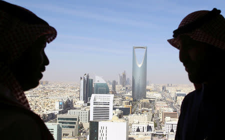 FILE PHOTO: Men look out of a building at the Kingdom Centre Tower in Riyadh, Saudi Arabia, January 1, 2017. REUTERS/Faisal Al Nasser/File Photo