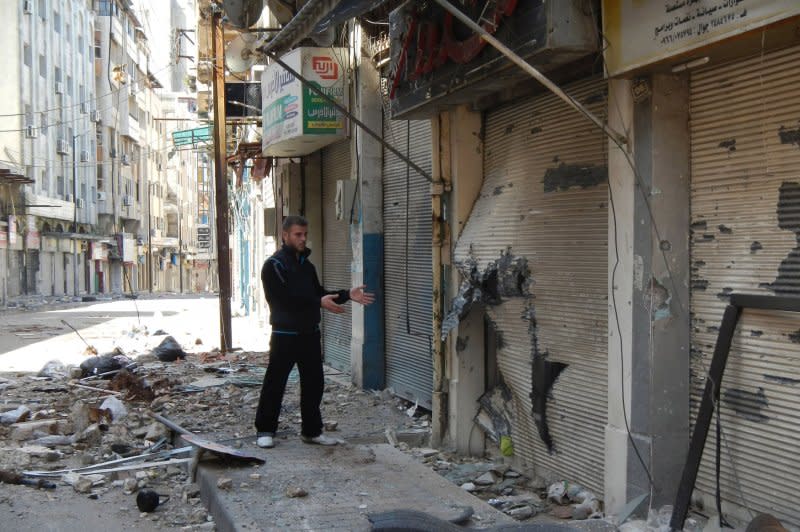 A Syrian man looks at damaged buildings in downtown Homs, Syria, in 2012. Homs was the site of heavy clashes between rebels and Syrian troops earlier this month. Dozens died in a month-long shelling on the area in February. UPI File Photo