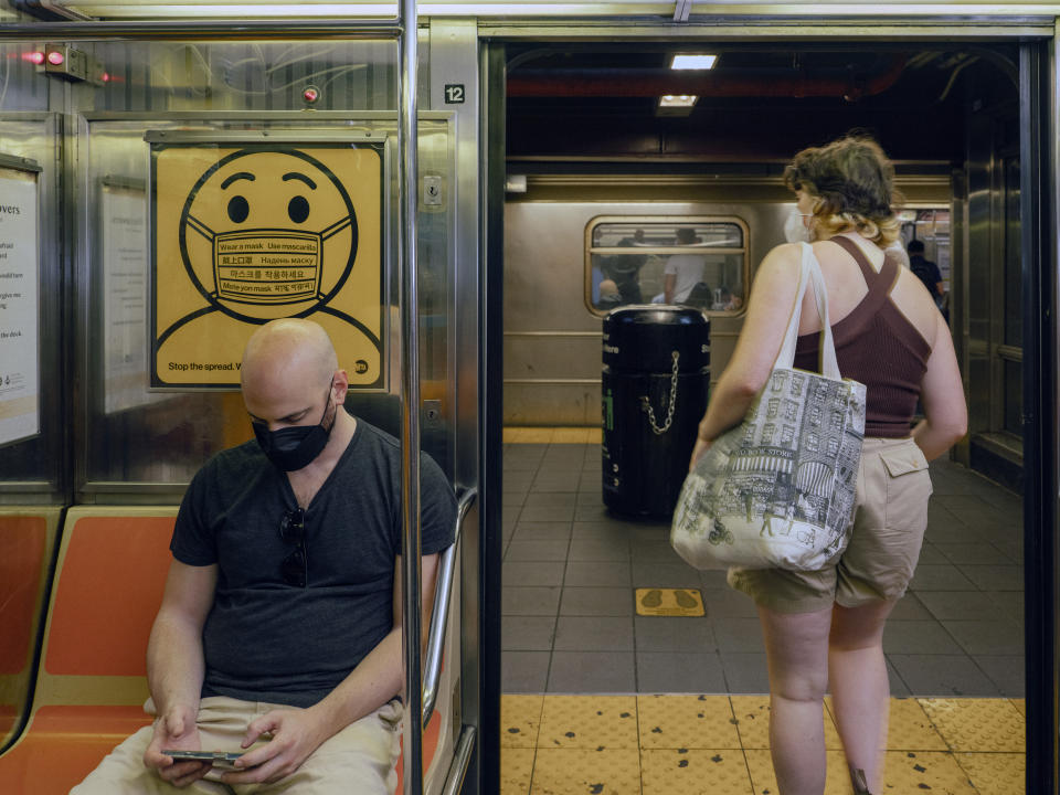 A sign in the New York City subway urges customers to wear a mask