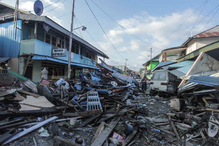 A man walks on a street after an earthquake and tsunami hit the area in Wani, Donggala, Central Sulawesi. Antara Foto/Muhammad Adimaja/ via REUTERS