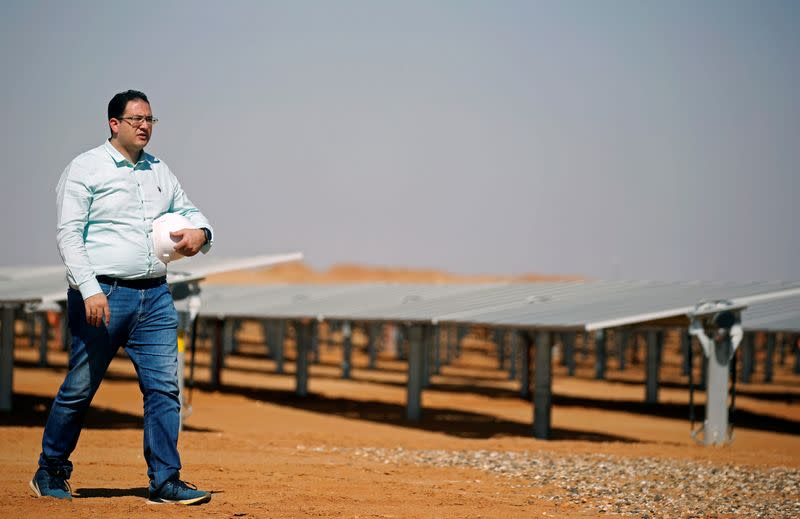 Mohamed Ossama, Project Director for solar energy at Taqa Arabia walks after an interview with Reuters near photovoltaic panels at the Benban plant in Aswan