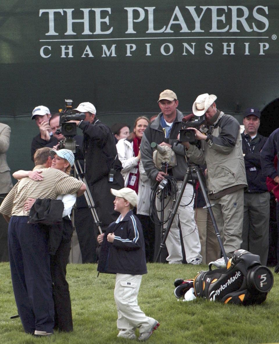 Davis Love III is greeted by his wife Robin and their 9-year-old son Dru after he won his second Players Championship in 2003.
