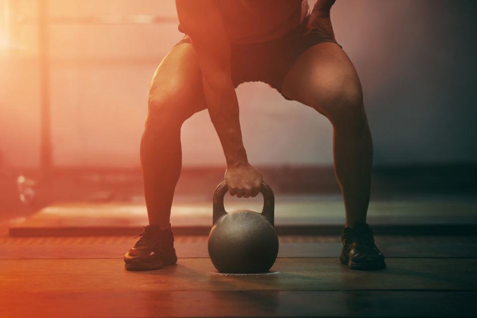 fitness, gym and sports training with kettlebell of athlete in exercise, workout and motivation indoors strong athletic hand ready with sport equipment exercising for strength, health and wellness