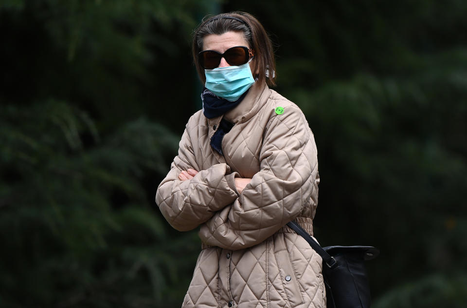 MELBOURNE, AUSTRALIA - JULY 20: A woman wearing a face mask walks through the city on July 20, 2020 in Melbourne, Australia. Victoria has recorded 275 new cases of coronavirus, and another death overnight. The death of the woman in her 80s brings the total number of deaths linked to COVID-19 in the state to 39. Metropolitan Melbourne and the Mitchell shire remain in lockdown due to the rise in COVID-19 cases through community transmissions, with residents in lockdown areas under stay at home orders until 19 August. People are only able to leave home have for exercise or work, to buy essential items including food or to access childcare and healthcare. Face masks or coverings will be mandatory from Thursday 23 July, with $200 fines to apply for not wearing face coverings.  (Photo by Quinn Rooney/Getty Images)