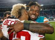 Dec 14, 2015; Miami Gardens, FL, USA; New York Giants wide receiver Odell Beckham Jr (13) hugs Miami Dolphins wide receiver Jarvis Landry (14) after the Giants defeated the dolphins 31-24 at Sun Life Stadium. Mandatory Credit: Andrew Innerarity-USA TODAY Sports