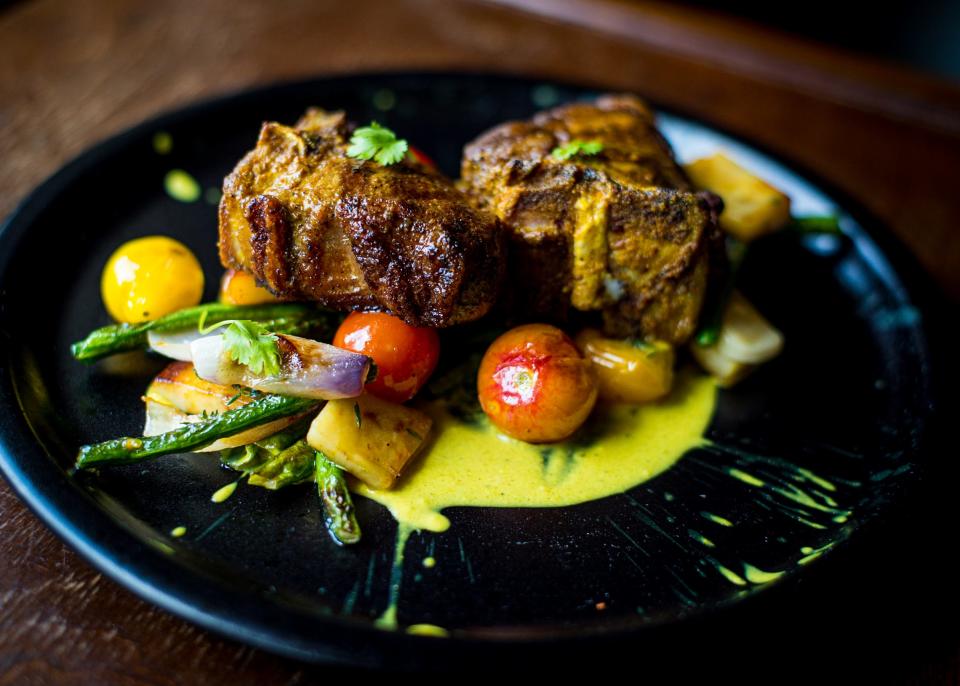 A reinterpretation of traditional Jamaican curry goat made by Kwame Williams, otherwise known as Chef Kwill, that is a curry lamb dish with roasted yams, long beans and cherry tomatoes.