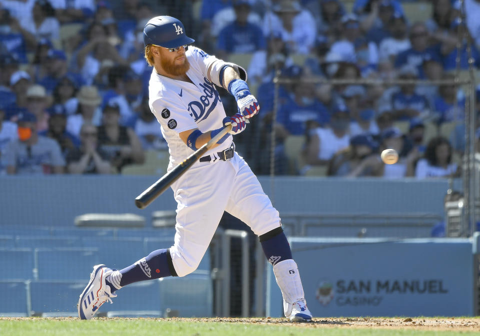 Los Angeles Dodgers' Justin Turner hits a three-run home run against the San Diego Padres in the seventh inning in a baseball game Sunday, Sept. 12, 2021, in Los Angeles, Calif. (AP Photo/John McCoy)