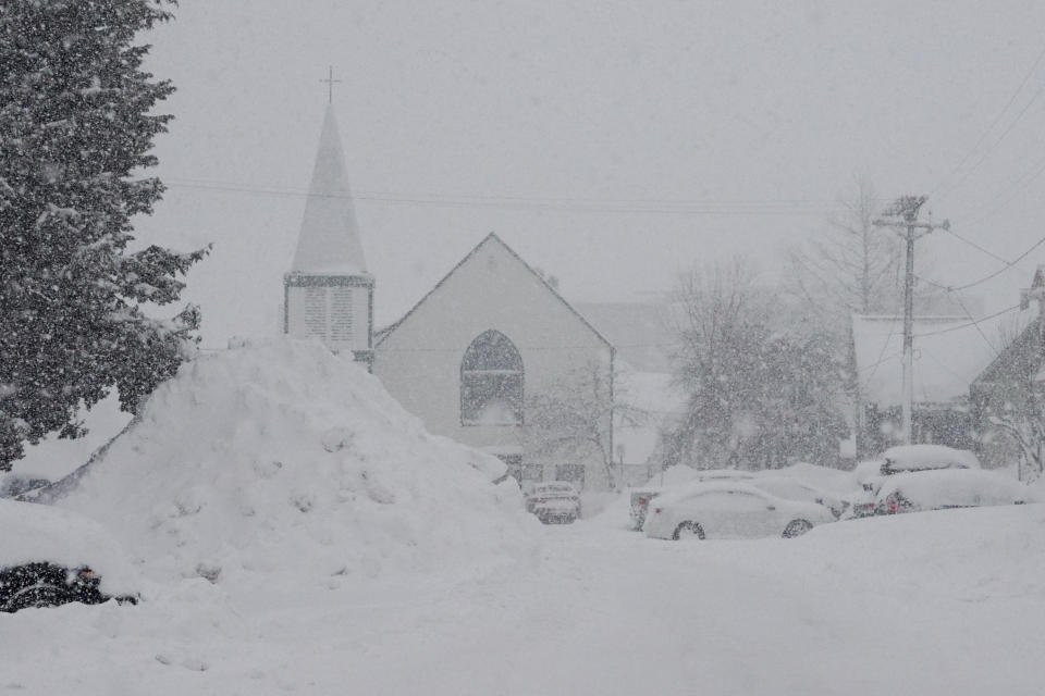 Snow piles up in front of a church during a storm, Sunday, March 3, 2024, in Truckee, Calif. (AP Photo/Brooke Hess-Homeier)