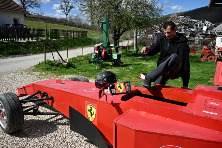 Bosnian mechanic Himzo Beganovic bought a replica Ferrari red car from another racing superfan in the capital Sarajevo last year (Elvis BARUKCIC)