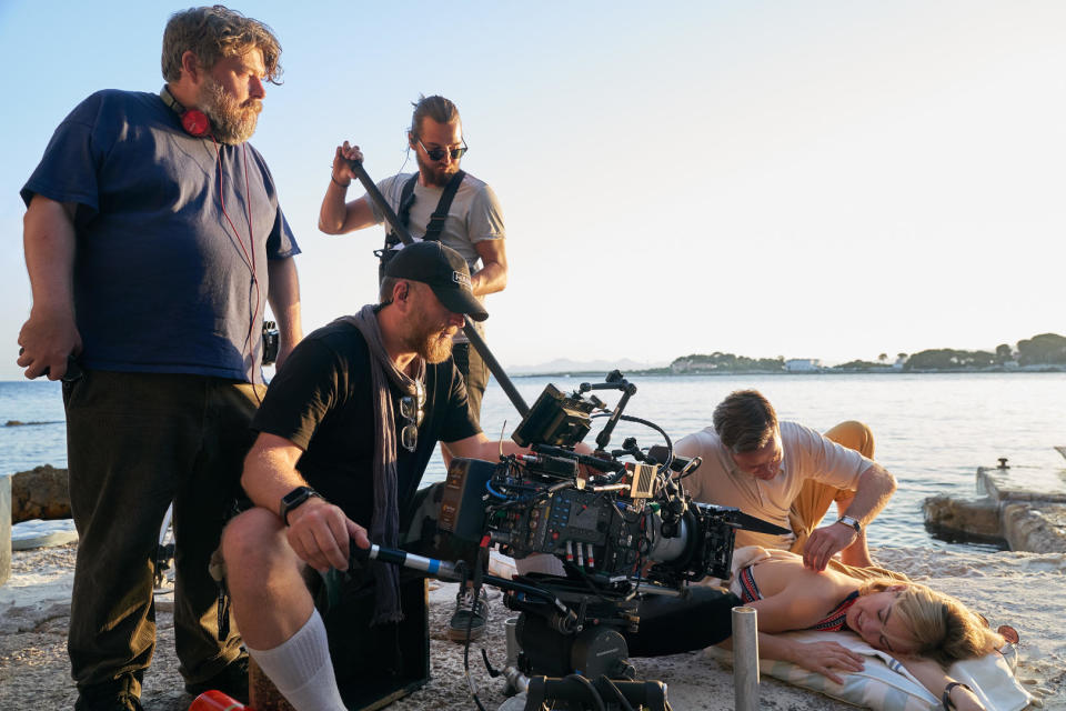 (L to R) Director Ben Wheatley, two members of the crew, and Armie Hammer as Maxim de Winter and Lily James as Mrs. de Winter on the set of Rebecca.