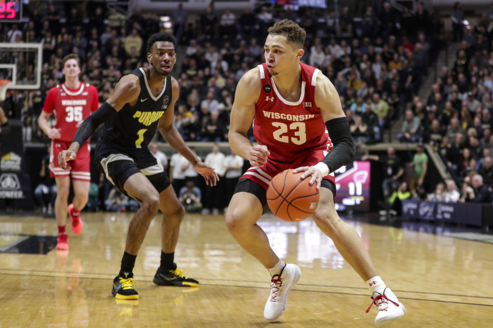Wisconsin guard Kobe King (23) drives on Purdue forward Aaron Wheeler (1) during the first half of an NCAA college basketball game in West Lafayette, Ind., Friday, Jan. 24, 2020. (AP Photo/Michael Conroy)