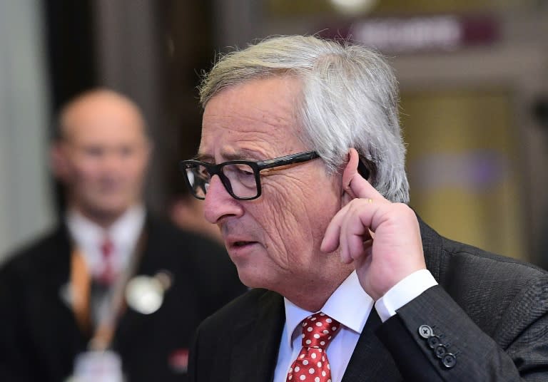 European Commission President Jean-Claude Juncker gestures while listening to journalists' questions as he leaves at the end of an European Union leaders summit on October 21, 2016 at the European Council, in Brussels