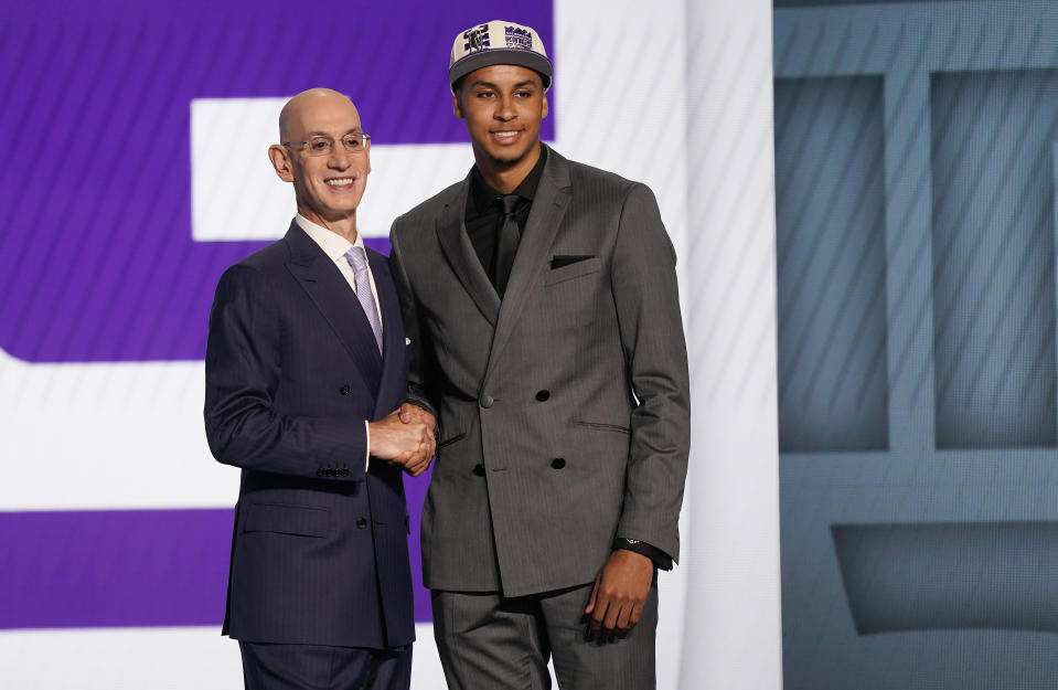 Keegan Murray, right, poses for photos with NBA Commissioner Adam Silver after being selected fourth overall by the Sacramento Kings in the NBA basketball draft, Thursday, June 23, 2022, in New York. (AP Photo/John Minchillo)