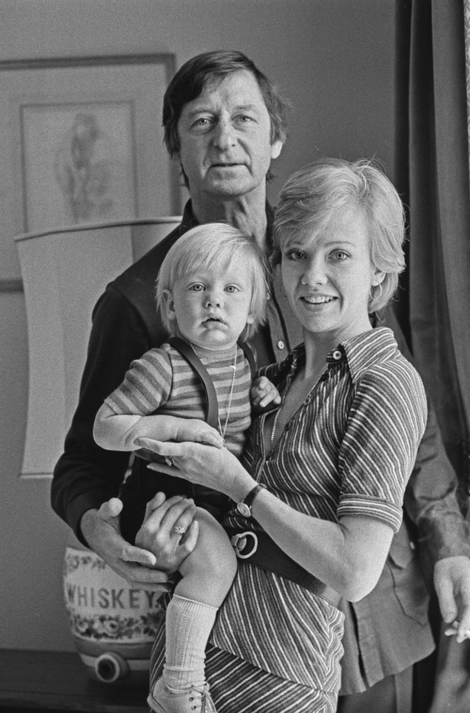 A black-and-white photo of a man, a woman and a child