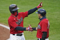 Cleveland Indians' Francisco Lindor, left, is congratulated by Cesar Hernandez after Lindor hit a two-run home run during the third inning of the team's baseball game against the Kansas City Royals, Tuesday, Sept. 8, 2020, in Cleveland. (AP Photo/Tony Dejak)
