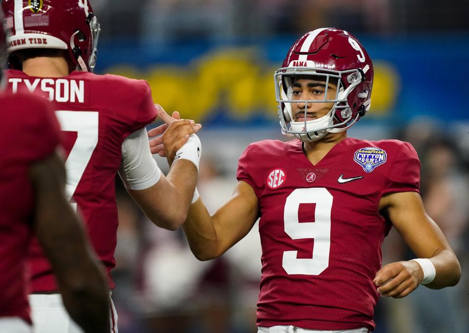 Alabama quarterback Bryce Young (9) greets fellow Alabama quarterback Paul Tyson (17) as they take the field for warm ups before the 2021 College Football Playoff Semifinal game at the 86th Cotton Bowl in AT&T Stadium in Arlington, Texas Friday, Dec. 31, 2021. [Staff Photo/Gary Cosby Jr.]