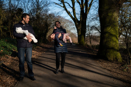 Adi, 37, who works for a removal company, and wife Maria, 31, take their daughters, Elena, who is two years and seven-months old and baby Ioana, who is less than a week old, for a walk in Hampstead Heath, near their home in London, Britain, February 3, 2019. REUTERS/Alecsandra Dragoi