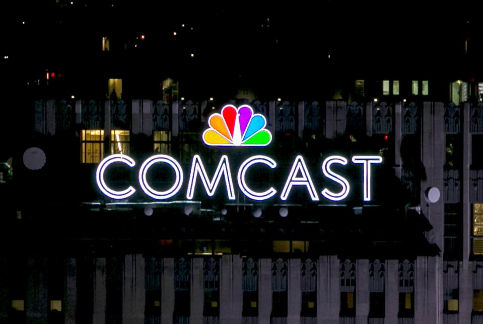 FILE PHOTO: The NBC and Comcast logo are displayed on top of 30 Rockefeller Plaza, formerly known as the GE building, in New York, New York, U.S. on July 1, 2015.  REUTERS/Brendan McDermid/File Photo