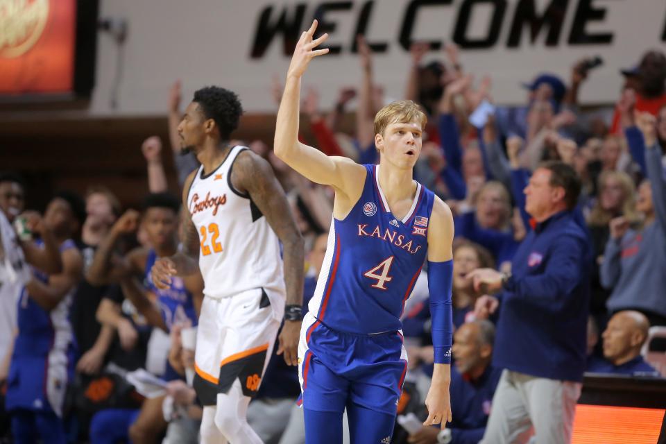 Kansas guard Gradey Dick (4) celebrates beside Oklahoma State forward Kalib Boone (22) after making a 3-pointer during a game Tuesday at Gallagher-Iba Arena in Stillwater, Oklahoma.