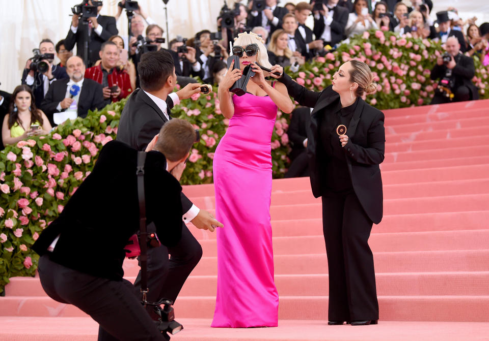 Lady Gaga’s third look was a hot pink dress complete with retro sunnies and a brick-sized phone [Photo: Getty]