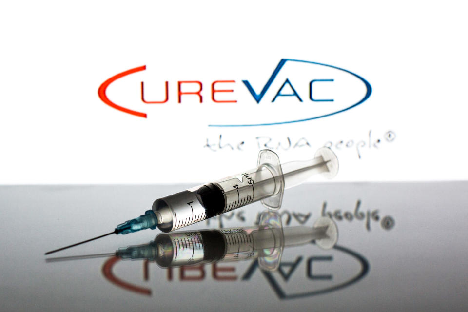 SPAIN - 2021/06/18: In this photo illustration a medical syringe seen displayed in front of the CureVac NV logo. (Photo Illustration by Thiago Prudencio/SOPA Images/LightRocket via Getty Images)