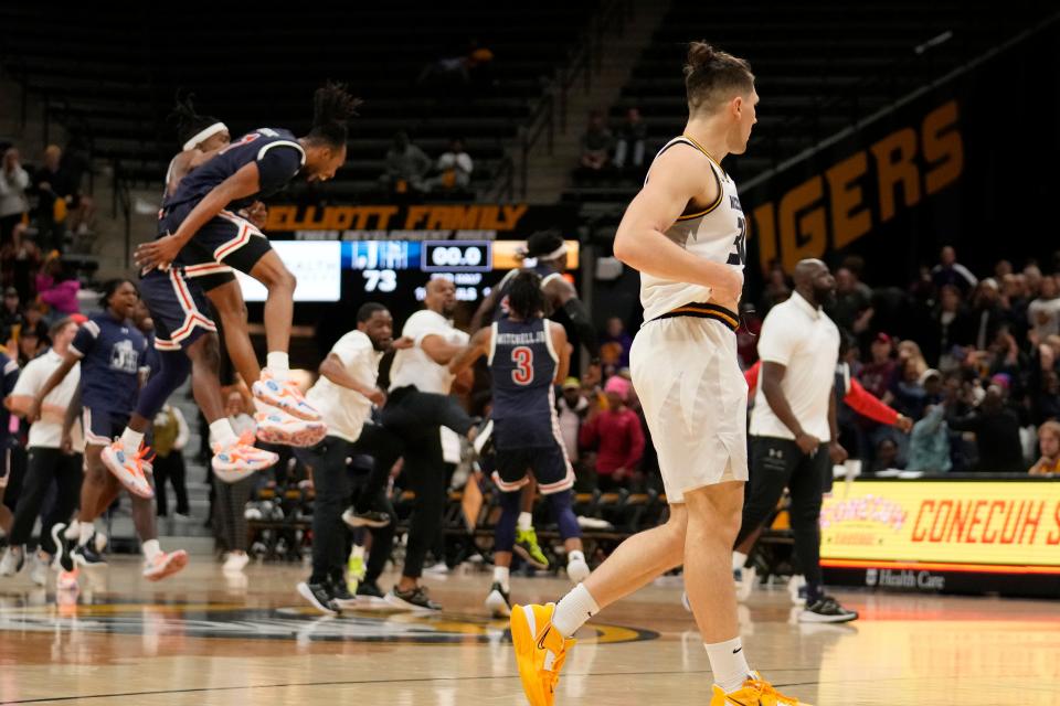 Missouri's Caleb Grill, right, walks away as members of Jackson State celebrate a 73-72 victory following an NCAA college basketball game Sunday, Nov. 19, 2023, in Columbia, Mo. (AP Photo/Jeff Roberson)