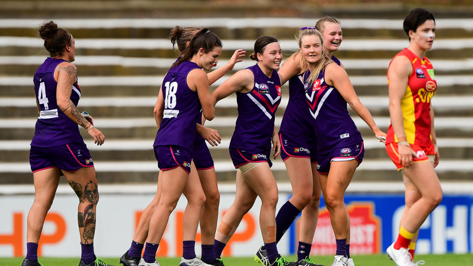 Fremantle Dockers players, pictured here celebrating a goal in their AFLW semi-final against Gold Coast.